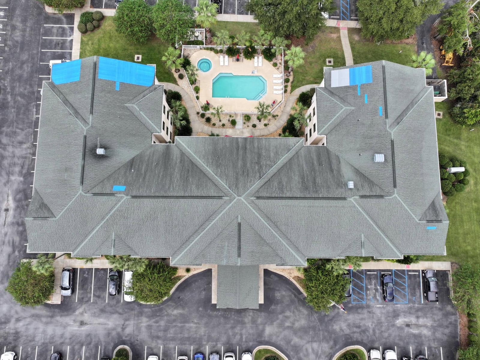 Blue tarp holding the weather back on a clubhouse roof until the replacement goes on.