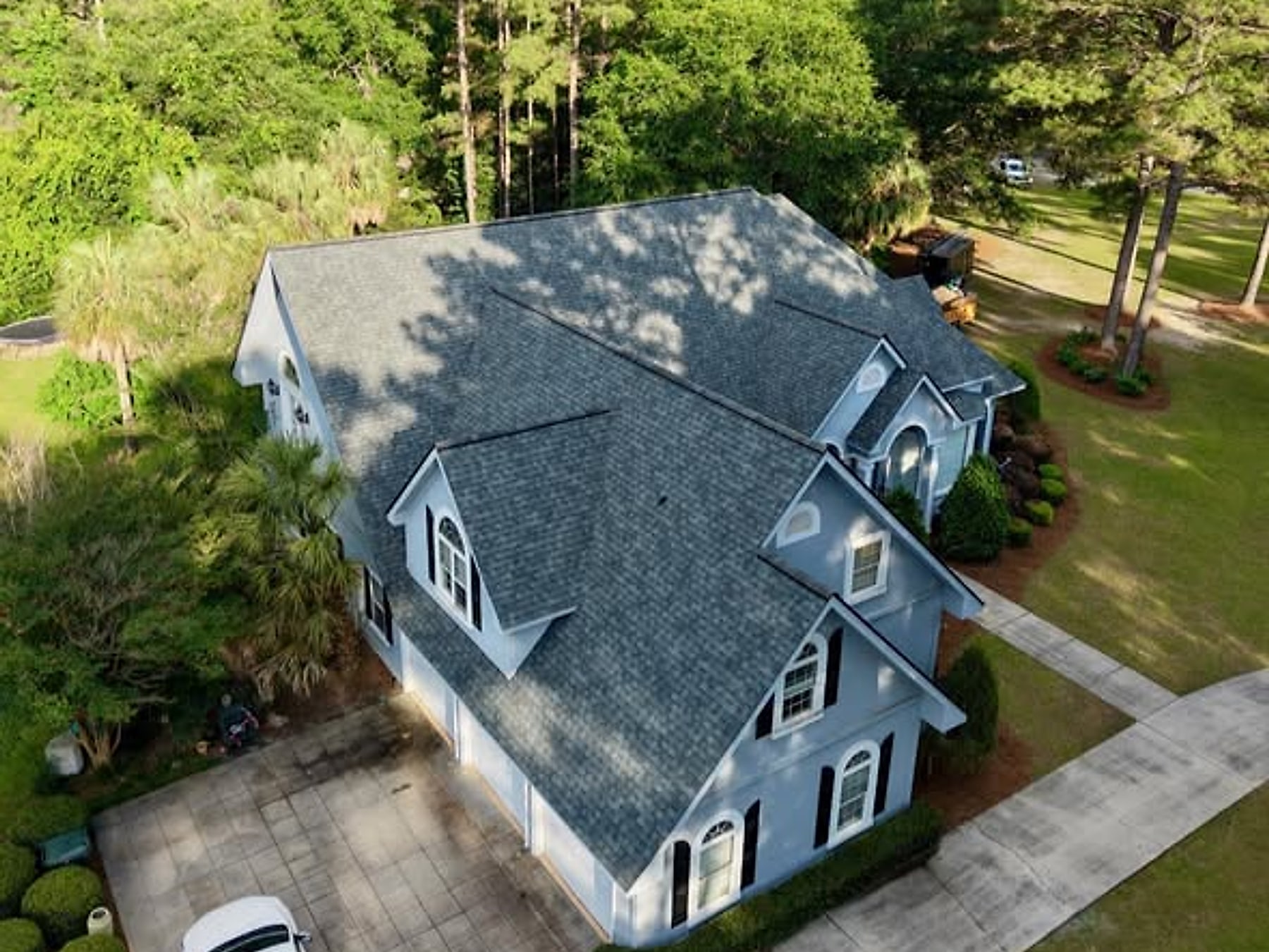 Shingles Down — Architectural shingles laid, ridges capped, valleys and flashing sealed.